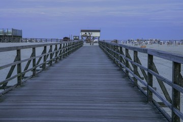 Fototapeta premium footbridge and stilt house in Sankt Peter-Ording