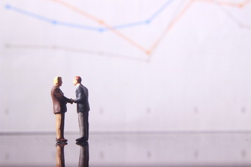 Simple Illustration Photo for Silhouette Two Man Handshaking for Business Agreement with graphic Chart as a background