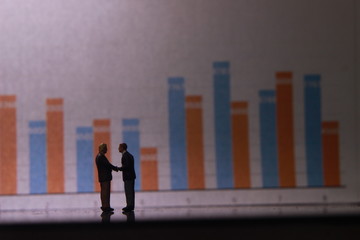Simple Illustration Photo for Silhouette Two Man Handshaking and Business Agreement with graphic Chart as a background