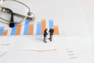 Simple Illustration Photo Two Businessman Handshaking at Graphic Business Chart 