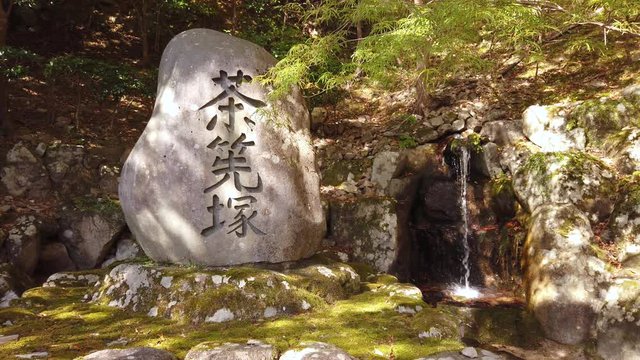 Shrine stone at Eigenji Temple, Shiga, Japan. Small stream dripping over mossy rocks