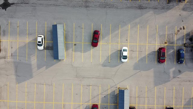 Red Car Pulling Int Parking Lot Aerial View By Shopping Cart Storage