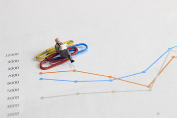 Simple Illustration Photo 1 Sitting old man Toy Reading Graphic Business Chart at colorful paperclip