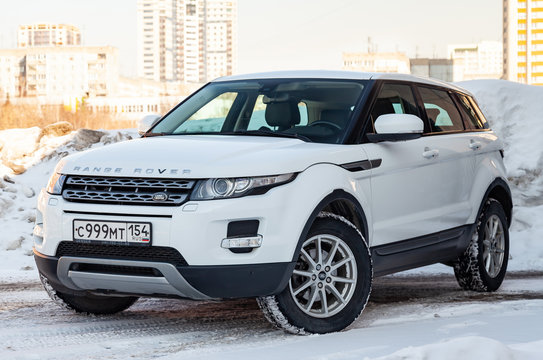Front view of Range Rover Land Rover Evoque in white color after cleaning before sale in a winter day and snow background