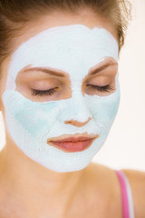 Fototapeta premium Girl with green mud mask on face