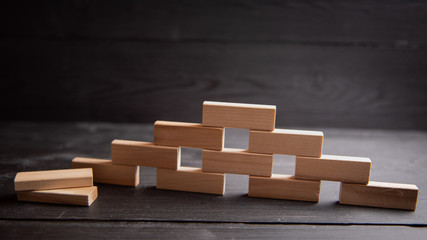 Obraz premium form for network marketing text. Wooden cubes laid out in the form of a pyramid