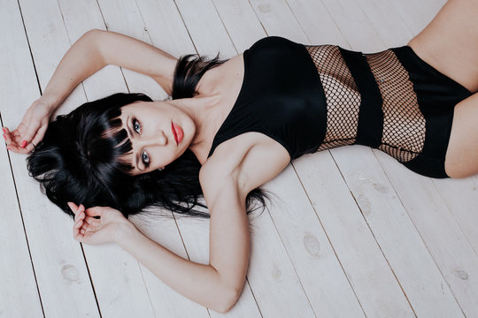 beautiful girl in black underwear lying on the floor