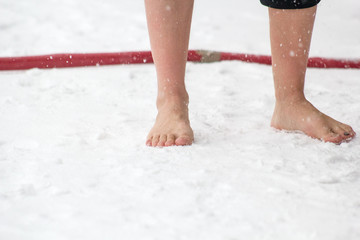 Caucasian Male Standing in Snow Barefoot
