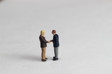Gray Backgrond, Simple Illustration Photo for Mini Figure Two Man Toy Handshaking for Business...