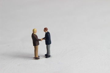 Gray Backgrond, Simple Illustration Photo for Mini Figure Two Man Toy Handshaking for Business...