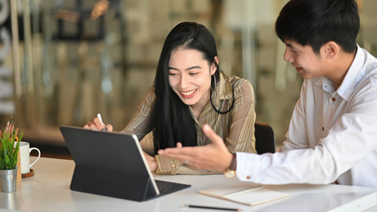 Asian business people they meeting with digital tablet on modern office.