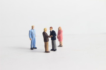 Gray Backgrond, Simple Illustration Photo for Mini Figure Two Man Toy Handshaking for Business Agreement Beyond their partner