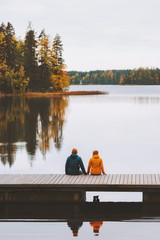 Couple traveling in Finland family lifestyle love relationship man and woman friends sitting on...