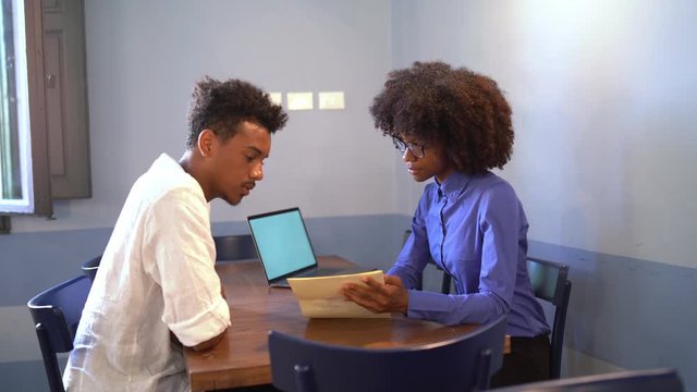 Young students discussing a project in a cafe