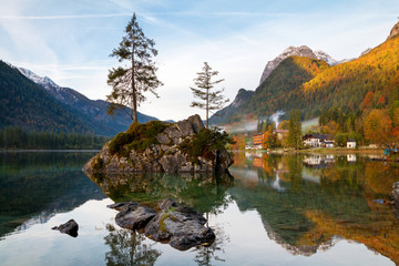 Beautiful autumn colors in the sunrise at the Hintersee lake in Bavaria alps