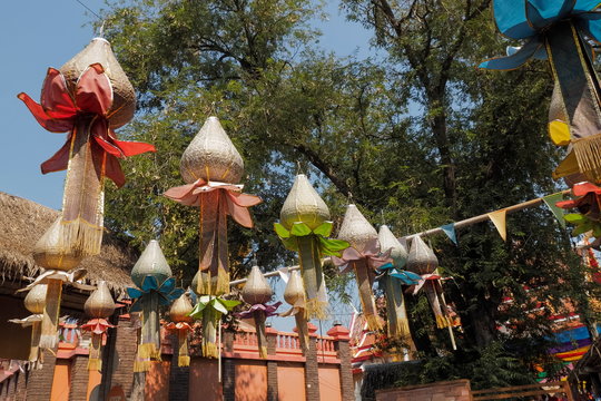 view of many lanterns lutus shape hang on rope with green trees and blue sky background, Kubua local market, Ratchaburi, Thailand.