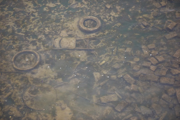 garbage dump at the bottom of the river under water