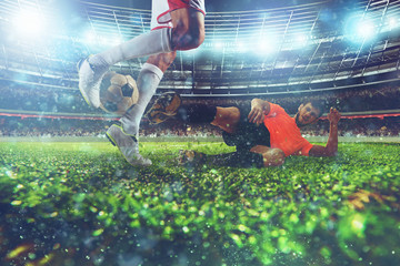Close up of a football action scene with competing soccer players at the stadium during a night match © alphaspirit