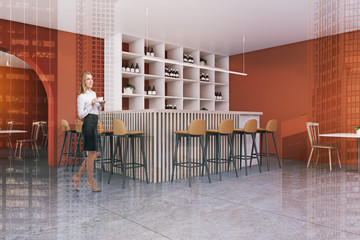 Blonde woman in orange pub