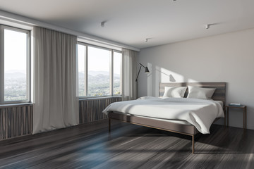 White and dark wooden master bedroom corner