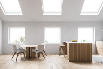 Attic white kitchen with bar and table, side view