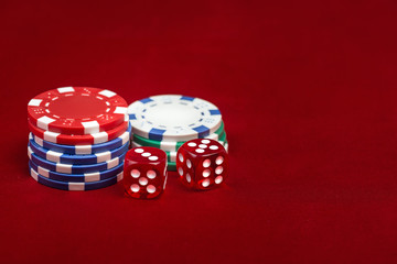 Dices and casino chps on red background