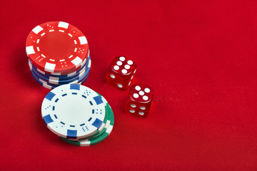 Dices and casino chps on red background