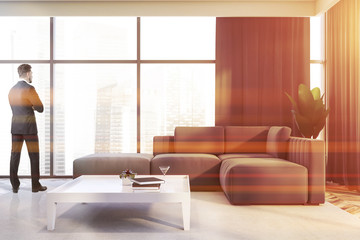 Man in gray living room with sofa