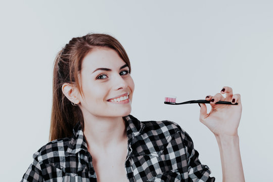 the girl in the bathtub with a toothbrush teeth smile