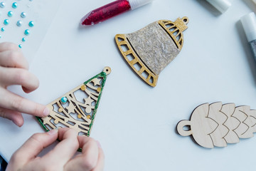 Workshop, girl mades a wooden christmas ornaments. Material for creativity. Step-by-step master...