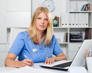 Woman doctor sitting at workplace