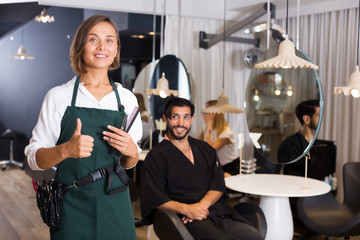 positive woman hairdresser thumbs up