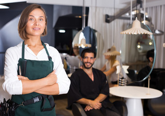 smiling woman hairdresser with male visitor