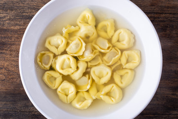 Tortellini in broth. Italian traditional dish. Winter food. Top view.