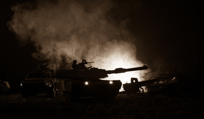Military patrol car on sunset background. Army war concept. Silhouette of armored vehicle with...