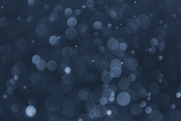 abstract sparkle bokeh light effect with navy blue background