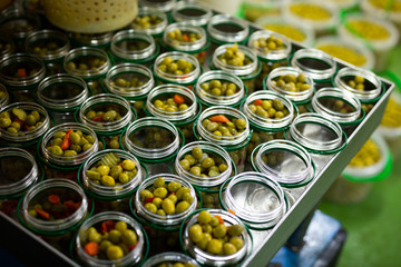 Glass cans filled with marinated olives