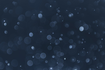 abstract sparkle bokeh light effect with navy blue background