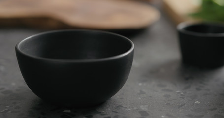 empty black bowl on terrazzo countertop
