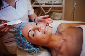 Obraz na płótnie Canvas doctor cosmetologist doing facial massage girl Spa