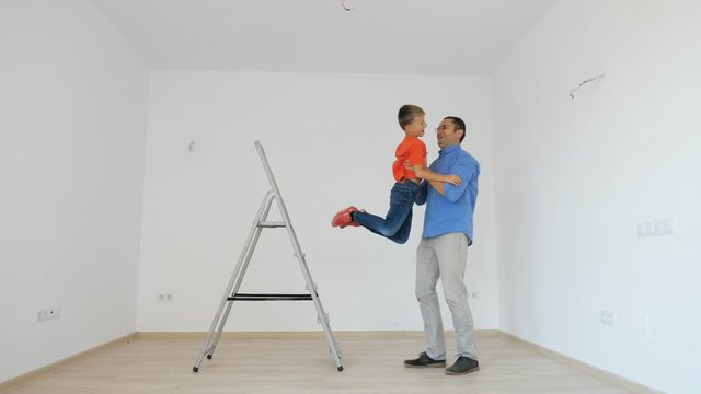 Father taking down child sitting up on ladder, boy flight, trust relationship