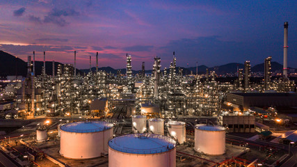Aerial view oil storage tank with oil refinery background, Oil refinery plant at twilight.