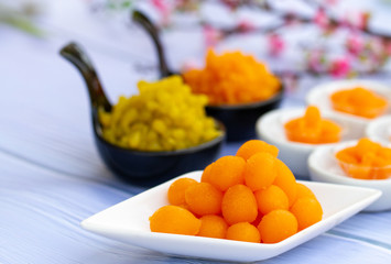 hai desserts. Tong Yord (Round Egg Yolk Tart) Egg yolk, sugar, and flower water are boiled in sugar syrup and formed into round balls.