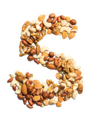 Letter S of the English alphabet from a mixture of hazelnuts, almonds, walnuts, peanuts, cashews, pumpkin seeds on a white isolated background. Food pattern made from nuts. Bright alphabet for shops.