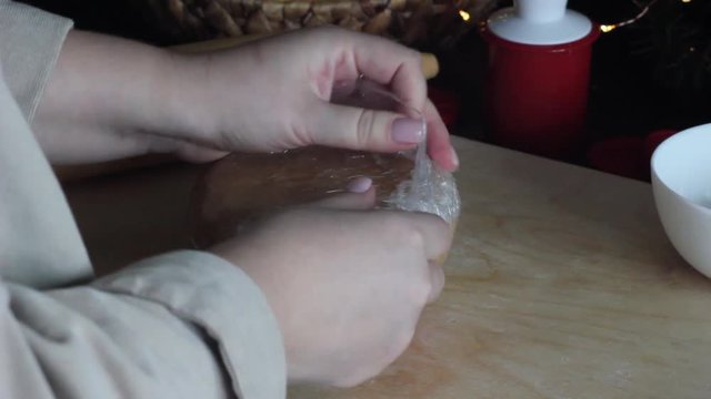 The unpacking of the dough for gingerbread cookies in plastic wrap.