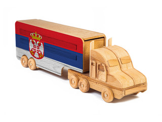 Close-up of a wooden toy truck with a painted national flag Serbia. The concept of export-import,transportation, national delivery of goods