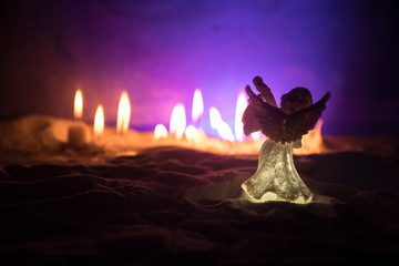 Little white guardian angel in snow. Festive background. Christmas and New Year concept. Selective...