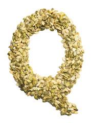 Letter Q of the English alphabet from pumpkin seeds on a white isolated background. Food pattern made from seeds. Bright alphabet for shops.