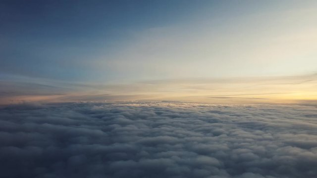 flaying above clouds at sunrise aerial view