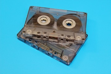 Plastic transparent audio cassettes located on a blue background